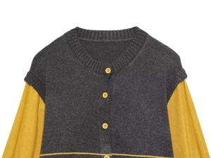 Detail view of dark grey V-neck knitted vest with yellow sleeves and matching buttons