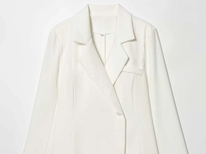 Detailed view of white minimalist blazer collar, notched lapel, and size S label