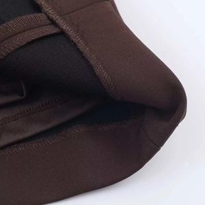 Detail view of the brown knit dress hem with black thermal lining and double stitching