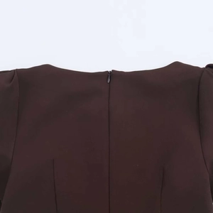 Detail view of a dark brown summer dress featuring a high-quality invisible back zipper