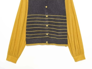 Detail of color-block knit cardigan featuring yellow striped sleeves and grey body texture