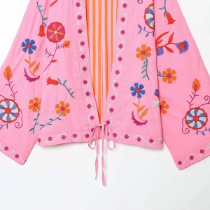 Pink kaftan cardigan with colorful floral embroidery and ethnic-style tie-front closure