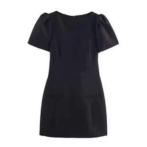 Detail of a minimalist short sleeve black dress with pleated pockets and slim waist