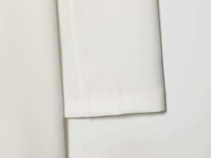 Detail view of clean white woven fabric texture and precise stitching on the sleeve cuff