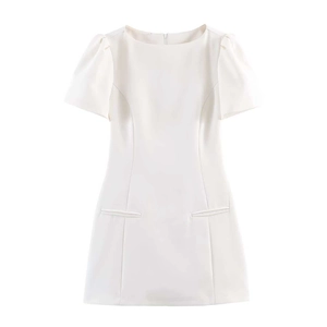Detail view of the white short-sleeve mini dress with puff sleeves and decorative pockets