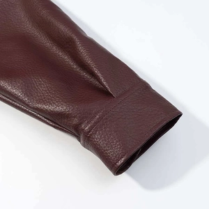 Detailed macro view showing the premium dark red leather texture and stitching on the cuff
