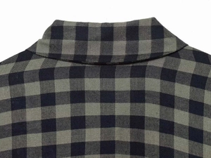 Macro detail of the black and grey gingham shirt collar and woven fabric texture