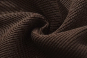 Macro view of dark brown ribbed knit fabric texture on this stylish pleated dress