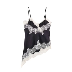 Detail of black satin camisole featuring white eyelash lace and asymmetrical hemline