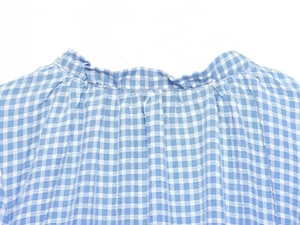 Detailed macro view showing the blue and white checkered pattern with refined pleat design