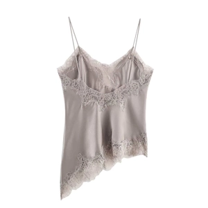 Close-up of silk satin camisole with delicate eyelash lace trim and asymmetric hemline