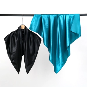 Glossy 90cm satin square scarves in black and peacock blue shown on minimalist hangers
