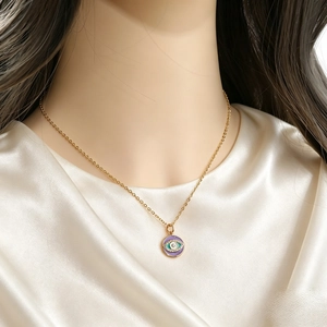Golden necklace featuring a round purple enamel Evil Eye pendant with zircon inlay