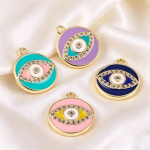 Macro view of colorful enamel evil eye charms with cubic zirconia for DIY jewelry