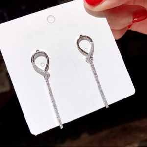Luxurious 925 silver long geometric drop earrings with full diamond pavé held by hand