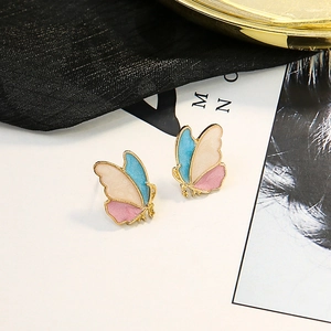 Macro shot of tricolor enamel butterfly earrings with gold finish and S925 silver needles