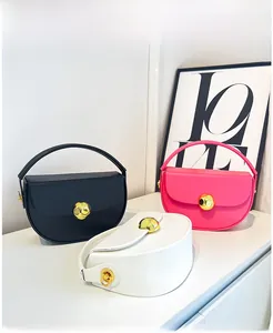 Three semi-circular handbags in black, white, and pink with a gold sphere metal lock