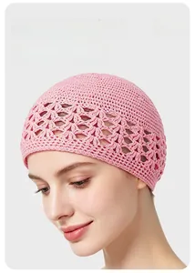 Detail of pink hand-crocheted wheat ear knit hat with hollow lace patterns for women