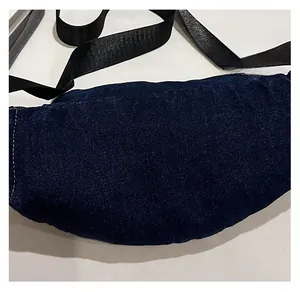 Detail view of premium dark blue denim waist bag showing durable twill texture and nylon strap