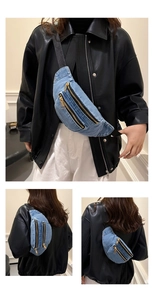 Detailed macro view of light blue denim waist bag with triple golden metal zippers