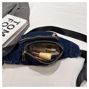 Detailed top view of dark blue denim fanny pack with cosmetics showing storage capacity