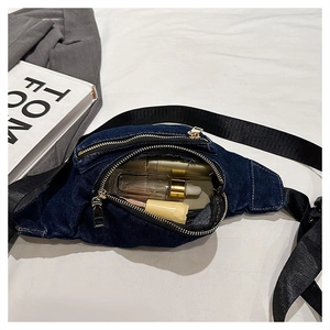 Detail view of the deep blue denim belt bag interior showing daily storage capacity