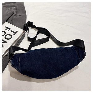 Detailed view of dark blue denim waist bag with contrast stitching and plastic buckle