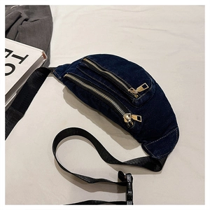 Detail view of denim waist bag featuring double gold zippers and adjustable strap
