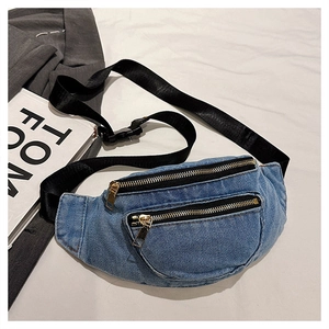 Flat lay of vintage blue denim waist bag with gold zippers and adjustable strap