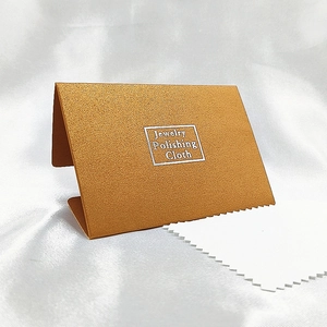 Polished jewelry cleaning cloth kit with elegant gold textured paper case and white cloth