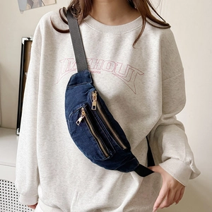 Versatile dark blue denim chest bag with gold zippers and adjustable strap for casual wear