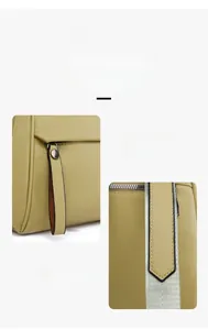 Detail view of the soft green leather backpack featuring long zipper pulls and lychee texture