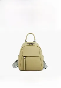 Detailed front view of a grass green soft leather backpack with lychee grain texture