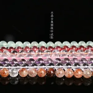 Macro display of mixed natural gemstone round beads including quartz and fluorite crystals