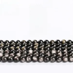 Macro shot of natural obsidian beads showing round shape and deep black luster