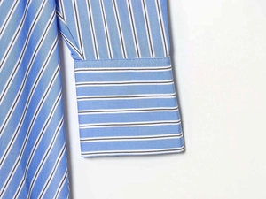 Close-up of blue and white striped shirt dress sleeve cuff with detailed stitching