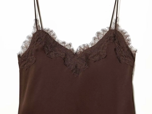 Close-up of deep brown satin camisole with delicate eyelash lace trim and V-neckline detail