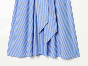 Detailed macro view of blue and white vertical striped fabric with asymmetric tie design