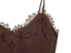Detailed close-up of dark brown camisole with delicate eyelash lace trim on V-neckline