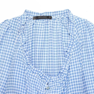 Blue and white gingham crop top for women featuring ruffles V-neck and a front button detail