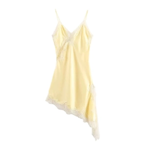 Détail de la robe en satin jaune clair avec dentelle blanche et ourlet asymétrique unique