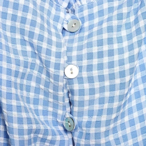 Blue and white gingham short shirt with pearlescent buttons and detailed fabric texture