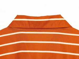 Detailed view of the orange and white striped shirt collar and shoulder stitching
