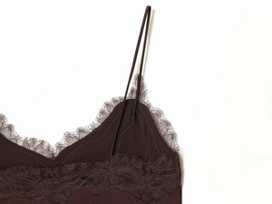 Detailed close-up of dark brown silk camisole with delicate floral eyelash lace at the V-neckline