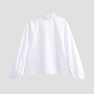 Detail of white blouse featuring ruffled V-neckline and voluminous lantern sleeves