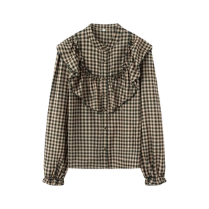 Green and black plaid long sleeve shirt with layered ruffle trim on white background