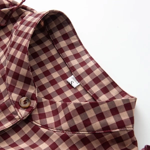 Red-brown and beige plaid shirt with stylish layered collar detail and amber button