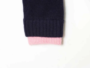 Detailed close-up of navy and pink double-layered ribbed knit cuffs with soft texture