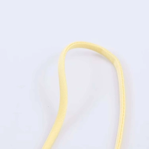 Detail of light yellow lace camisole strap featuring fine texture and even stitching