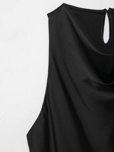Detailed view of black satin high neck with elegant drapes and teardrop back button